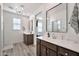 Elegant bathroom with dual vanities, quartz counters, and wood-look tile flooring at 4803 S Ferric --, Mesa, AZ 85212