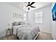 Bright bedroom with gray bedding, a ceiling fan, a window, and an accent 'LOVE' decoration at 4803 S Ferric --, Mesa, AZ 85212