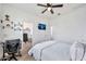 Bright bedroom featuring carpet, a ceiling fan, a closet, and a home office setup at 4803 S Ferric --, Mesa, AZ 85212