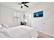 Bright bedroom with carpet, a ceiling fan, a home office setup, and a window at 4803 S Ferric --, Mesa, AZ 85212