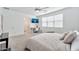 Bright bedroom featuring carpet, a ceiling fan, a home office setup, and a door to the Primary bath at 4803 S Ferric --, Mesa, AZ 85212