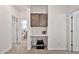 Hallway featuring built-in cabinet, desk, and entry to bathroom with toilet and sink visible at 4803 S Ferric --, Mesa, AZ 85212