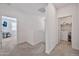 Upstairs hallway leading to the laundry room and a bedroom with a home office setup at 4803 S Ferric --, Mesa, AZ 85212