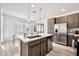 Bright kitchen with stainless steel appliances and an island overlooking the dining area at 4803 S Ferric --, Mesa, AZ 85212