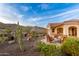 Cozy back patio featuring a fire pit, comfortable seating, and desert landscaping with beautiful mountain views at 4946 N 210Th Ave, Buckeye, AZ 85396