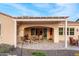 Inviting covered patio with a dining area and comfortable seating, perfect for outdoor relaxation and entertaining at 4946 N 210Th Ave, Buckeye, AZ 85396
