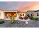 Backyard view with covered patio, fire pit, and desert landscaping at 4946 N 210Th Ave, Buckeye, AZ 85396