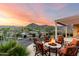 Outdoor patio featuring seating around a fire pit with sunset at 4946 N 210Th Ave, Buckeye, AZ 85396