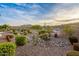 Well-maintained backyard with desert landscaping, a view of the golf course, and beautiful mountain scenery at 4946 N 210Th Ave, Buckeye, AZ 85396