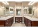 Bright bathroom featuring dual sinks, vanity space, dark wood cabinets, and nice lighting at 4946 N 210Th Ave, Buckeye, AZ 85396