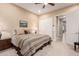Bright bedroom features a ceiling fan, closet with sliding doors, and an open doorway at 4946 N 210Th Ave, Buckeye, AZ 85396