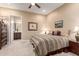 This comfortable bedroom with a ceiling fan connects to a bathroom via an open doorway at 4946 N 210Th Ave, Buckeye, AZ 85396