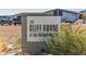 Sign for The Cliff House at The Victory Steps, with natural desert foliage at 4946 N 210Th Ave, Buckeye, AZ 85396