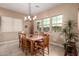 Bright dining room featuring a wood table, chairs, and views from the multiple windows providing plenty of natural light at 4946 N 210Th Ave, Buckeye, AZ 85396