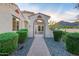 Close up of the arched entryway to a single-story home with beautiful desert landscaping at 4946 N 210Th Ave, Buckeye, AZ 85396
