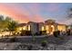 Attractive single-story home boasts beautiful desert landscaping, an arched entryway and manicured shrubs at 4946 N 210Th Ave, Buckeye, AZ 85396
