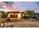 Beautiful single-story home featuring a well-kept front yard, desert landscaping and a brick-paved driveway at 4946 N 210Th Ave, Buckeye, AZ 85396