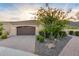 Cozy single-story home exhibits neat front yard, desert landscaping, brick-paved driveway and attached garage at 4946 N 210Th Ave, Buckeye, AZ 85396