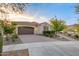 Attractive single-story home boasts beautiful desert landscaping, brick-paved driveway and attached garage at 4946 N 210Th Ave, Buckeye, AZ 85396