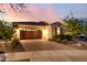 Beautiful single-story home featuring a well-kept front yard, desert landscaping and a brick-paved driveway at 4946 N 210Th Ave, Buckeye, AZ 85396