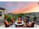 Outdoor patio with fire pit and seating, mountain views in background at 4946 N 210Th Ave, Buckeye, AZ 85396