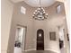 Elegant foyer featuring a statement chandelier, arched doorway, and neutral color palette at 4946 N 210Th Ave, Buckeye, AZ 85396