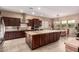 Gourmet kitchen with granite countertops, stainless steel appliances, and an island, adjacent to the dining room at 4946 N 210Th Ave, Buckeye, AZ 85396