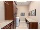 Spacious laundry room with storage cabinets, countertop and tiled floor at 4946 N 210Th Ave, Buckeye, AZ 85396