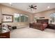 Spacious main bedroom with large windows offering natural light, ceiling fan, and furniture at 4946 N 210Th Ave, Buckeye, AZ 85396