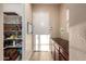 Convenient mud room/pantry featuring built-in storage cabinets, shelving, and access to the garage or outdoor area at 4946 N 210Th Ave, Buckeye, AZ 85396