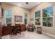 Bright home office with large windows, neutral walls, and traditional desk at 4946 N 210Th Ave, Buckeye, AZ 85396