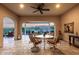 Covered outdoor patio with travertine flooring and ceiling fan at 4946 N 210Th Ave, Buckeye, AZ 85396
