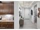 Bright hallway featuring modern lighting, neutral walls, gray flooring, and doorway to the adjacent bedroom at 4949 W Walatowa St, Laveen, AZ 85339