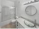 Bathroom featuring glass vessel sink, quartz counters and updated shower-tub combo at 5015 E Cheyenne Dr # 14, Phoenix, AZ 85044