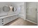 Bright bathroom with glass bowl sinks, modern fixtures, soaking tub, and walk-in shower at 5015 E Cheyenne Dr # 14, Phoenix, AZ 85044
