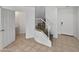 Hallway with staircase and access to a bathroom with white doors and neutral flooring at 5015 E Cheyenne Dr # 14, Phoenix, AZ 85044