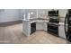 Modern kitchen features stainless steel appliances, white cabinets, and granite countertops at 5015 E Cheyenne Dr # 14, Phoenix, AZ 85044