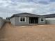 Spacious backyard showing the patio, windows, and newly built home at 5634 W Olney Ave, Laveen, AZ 85339