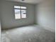 Neutral bedroom showcasing a window that offers natural light and scenic neighborhood views at 5634 W Olney Ave, Laveen, AZ 85339