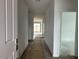 Bright hallway showcasing wood-look tile floors, leading to the living spaces and bedrooms at 5634 W Olney Ave, Laveen, AZ 85339
