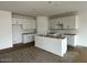 Modern kitchen with white cabinets, an island, and plenty of room to customize at 5634 W Olney Ave, Laveen, AZ 85339