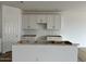 Bright kitchen showcases white cabinets, a center island, and an open design at 5634 W Olney Ave, Laveen, AZ 85339