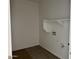 A dedicated laundry room with wood-look tile flooring and built-in shelving at 5634 W Olney Ave, Laveen, AZ 85339