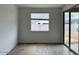 Bright living room with wood-style tile flooring and sliding glass door to backyard; great natural light at 5634 W Olney Ave, Laveen, AZ 85339