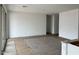 Open-concept living room featuring modern tile floors, large windows, and bright neutral walls at 5634 W Olney Ave, Laveen, AZ 85339