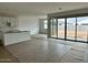 Open concept living area with tile flooring and sliding glass doors to the backyard at 5634 W Olney Ave, Laveen, AZ 85339