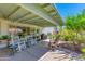 Back patio with a covered patio, chairs, and a lovely back yard at 6031 E Inglewood St, Mesa, AZ 85205