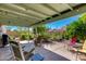 Relaxing back patio with covered seating, beautiful plants, and lovely backyard at 6031 E Inglewood St, Mesa, AZ 85205