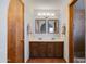 Bathroom featuring double sinks with framed mirrors, wood cabinets, and decorative tile flooring at 6031 E Inglewood St, Mesa, AZ 85205