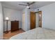 Bedroom features tile floor, ceiling fan, dresser, closet, and bathroom access at 6031 E Inglewood St, Mesa, AZ 85205